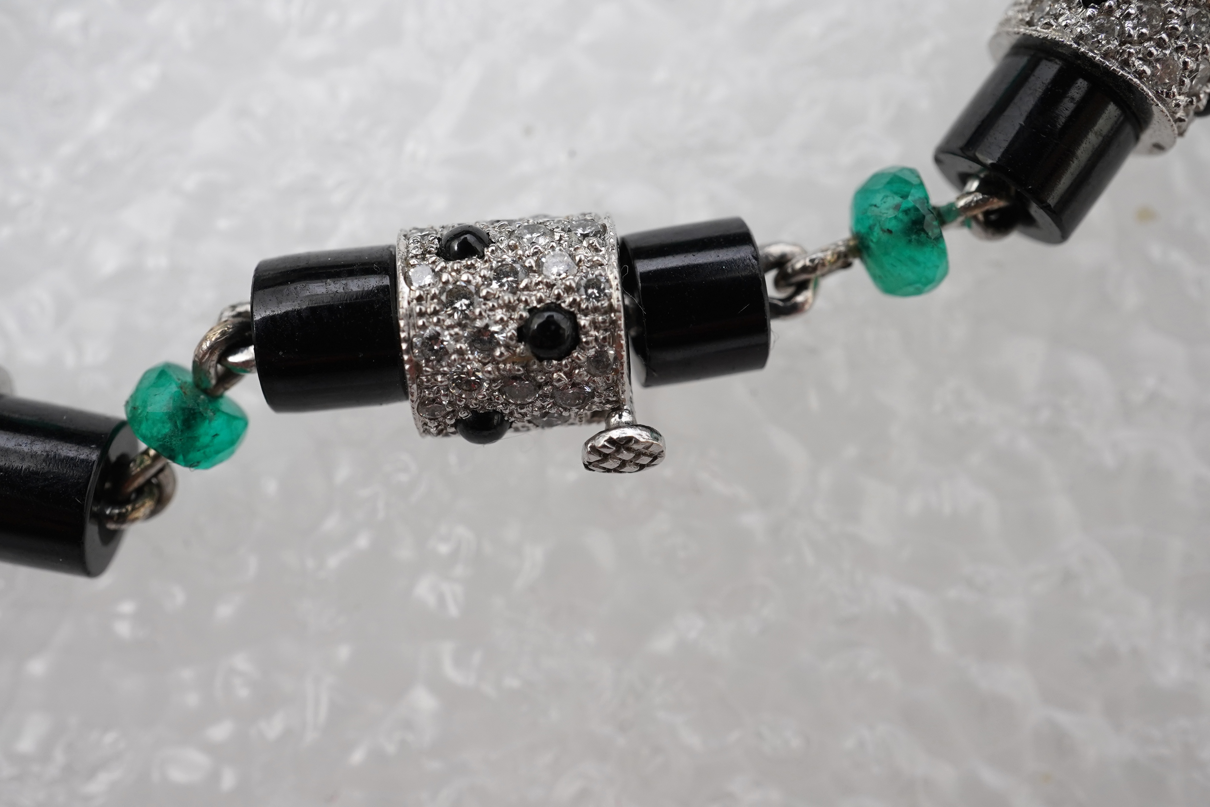 A stylish onyx, emerald and diamond bracelet